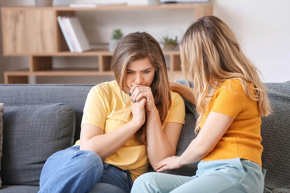 two people sit on a couch possibly wondering about a partial hospitalization program near me